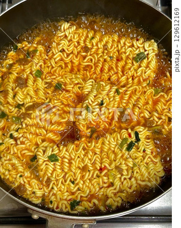 Delicious bowl of ramyeon with flavorful broth, tender noodles, and savory toppings. A comforting and satisfying Korean dish, perfect for a quick meal or cozy night in. Spicy, hearty, and delicious! 129612169