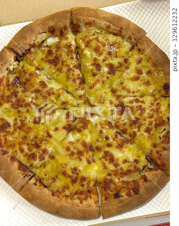 Cheesy pizza topped with golden french fries, combining crispy potato goodness with gooey, savory delight. A fun and indulgent twist on two favorite comfort foods. 129612232