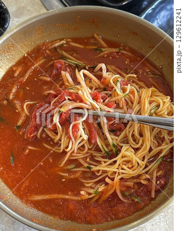 Fresh and refreshing Hanwoo mulhoe with tender beef, chilled broth, and crisp vegetables. A must-try Korean dish for those seeking a cool, light, and flavorful dining experience. 129612241