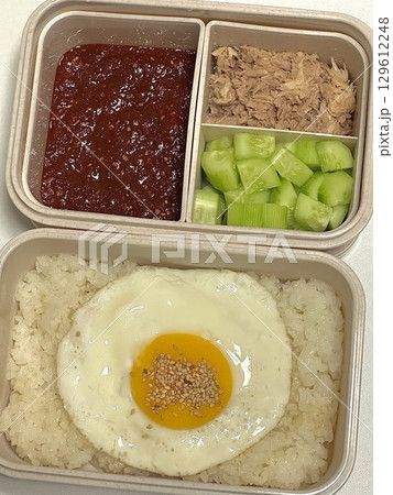 A traditional Korean dosirak, beautifully arranged with rice, assorted banchan, and savory proteins. Balanced and visually inviting, its a portable meal packed with vibrant flavors. A traditional Korean dosirak, beautifully arranged with rice, assorted banchan, and savory proteins. Balanced and visually inviting, its a portable meal packed with vibrant flavors. 129612248