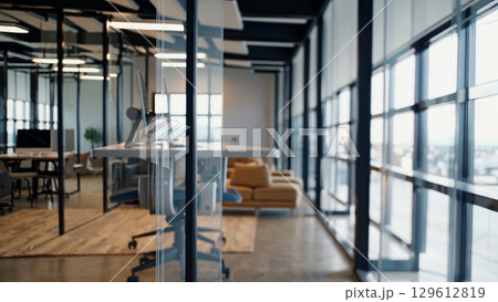 Height adjustable desk rising smoothly in a modern coworking space, featuring large windows, natural light, and comfortable furniture, creating a productive and inspiring work environment Height adjustable desk rising smoothly in a modern coworking space, featuring large windows, natural light, and comfortable furniture, creating a productive and inspiring work environment 129612819