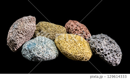 A colorful collection of porous volcanic rocks on black 129614333
