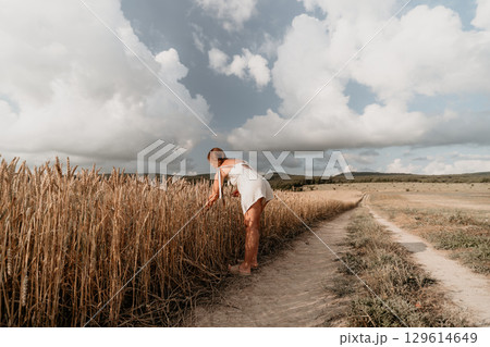 Woman in White Dress in Wheat Field 129614649