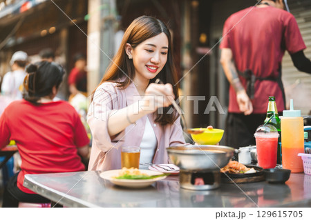 Traveler woman enjoy eating street food spicy thai tasty menu travel at chinatown Yaowarat, Bangkok Traveler woman enjoy eating street food spicy thai tasty menu travel at chinatown Yaowarat, Bangkok 129615705