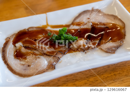 Chashu, a Japanese braised pork dish made with pork belly. It is a popular topping for ramen and other dishes. 129616067