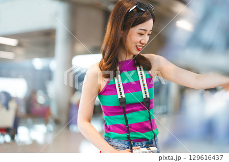 Asian woman consumer choosing food or seasoning product at supermarket store 129616437