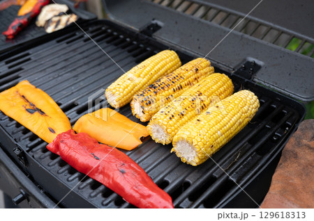 Grilled corn and peppers on a barbecue grill Grilled corn and peppers on a barbecue grill 129618313