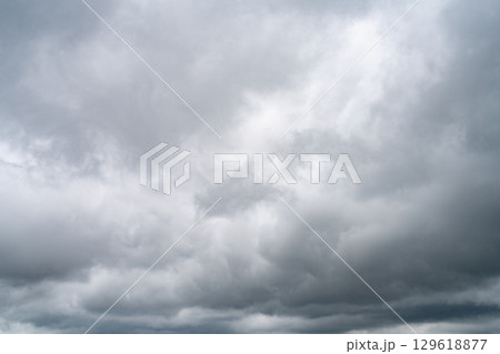 Dramatic overcast sky with gray and white clouds before rainy season storm, moody and gloomy weather background. Climate, meteorology, and atmospheric. Weather forecasting, climate change background. 129618877