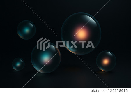 漆黒の空間に漂う発光コアを内包した透明球体の抽象背景 129618913