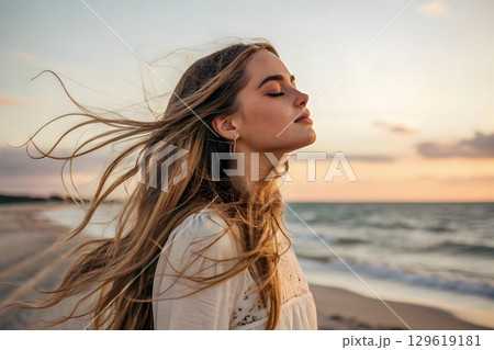 portrait of a beautiful young woman on the beach 129619181