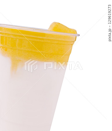 Creamy mango smoothie topped with fresh fruit served in a clear cup Creamy mango smoothie topped with fresh fruit served in a clear cup 129619273
