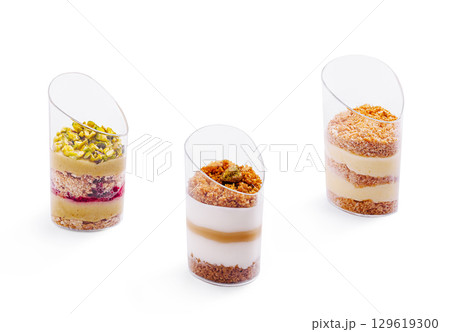 Exquisite layered desserts served in elegant transparent cups at a pastry shop 129619300