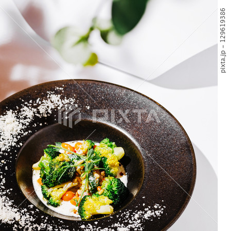 Freshly prepared vegetable dish served in a modern restaurant setting Freshly prepared vegetable dish served in a modern restaurant setting 129619386