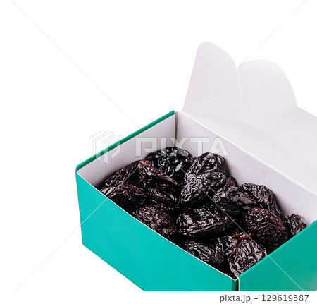 Dried fruits packed in a vibrant teal box on a white background 129619387