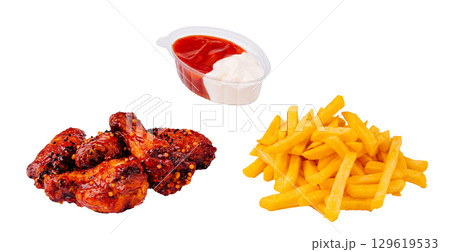 Delicious spicy chicken wings with crispy fries and dipping sauce 129619533