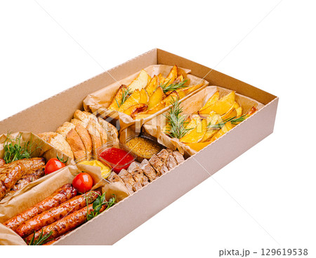 Delicious spread of assorted foods in a takeaway box with fresh ingredients Delicious spread of assorted foods in a takeaway box with fresh ingredients 129619538