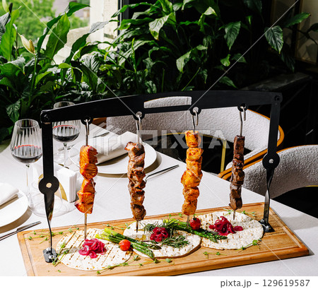 Enjoy delicious skewered kebabs with fresh herbs in vintage decor Enjoy delicious skewered kebabs with fresh herbs in vintage decor 129619587
