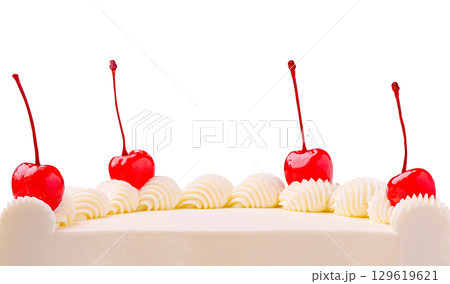 Celebration cake decorated with cherries and whipped cream on a white background 129619621