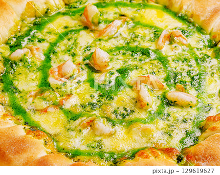 Delicious shrimp and pesto dish served in a crusty bowl during dinner 129619627