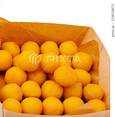 Delicious yellow sweets in a paper box at a local market 129619673