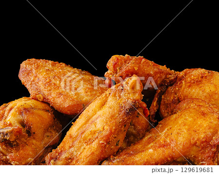 Fried chicken wings piled high, ready for a delicious meal 129619681