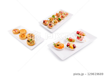 Delicious variety of appetizers served on white plates at a buffet 129619689