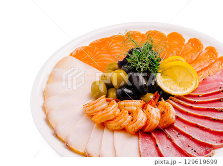 Delicious seafood platter featuring shrimp, olives, and various fish slices Delicious seafood platter featuring shrimp, olives, and various fish slices 129619699