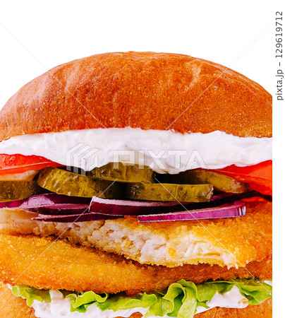 Delicious crispy fish sandwich with fresh toppings and creamy sauce 129619712