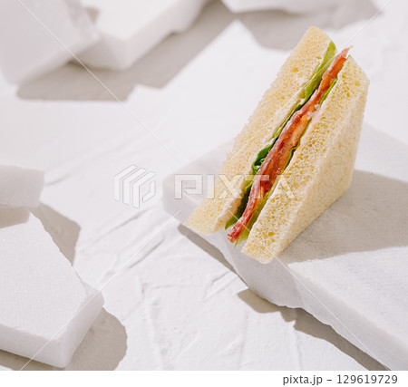 Sandwich placed on white textured surface for minimalist food styling Sandwich placed on white textured surface for minimalist food styling 129619729