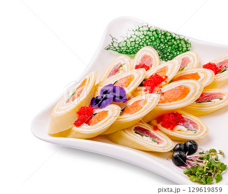 Colorful sushi rolls served on elegant platter with garnishes 129619859