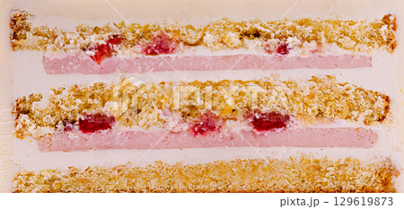 Delicious layered dessert with cream and strawberry filling on display 129619873