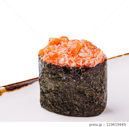 Sushi masterpiece featuring salmon on a bed of seaweed served in a restaurant Sushi masterpiece featuring salmon on a bed of seaweed served in a restaurant 129619949