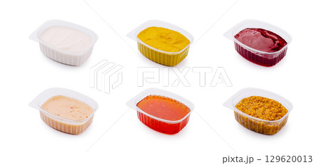 Assortment of colorful dipping sauces arranged in separate containers 129620013