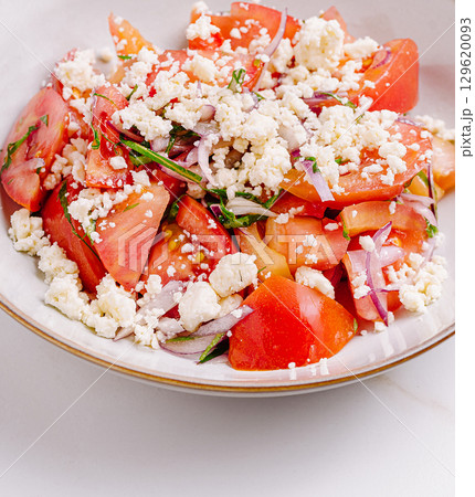 Fresh tomato salad with feta cheese and herbs for healthy eating Fresh tomato salad with feta cheese and herbs for healthy eating 129620093
