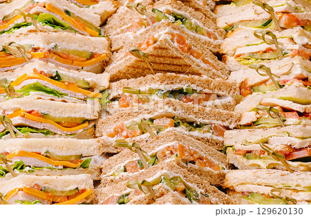 Delicious assorted sandwich platter prepared for a lunchtime gathering Delicious assorted sandwich platter prepared for a lunchtime gathering 129620130