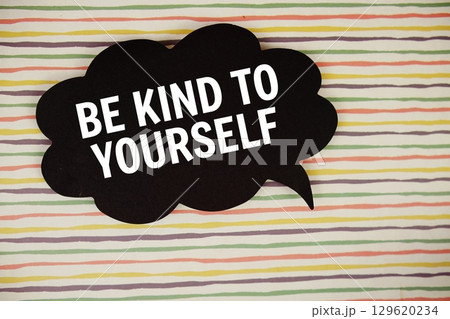 Be Kind To Yourself text with speech bubble top view on colorful stripes background 129620234