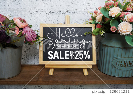 Spring Sale 25% Promotion and Marketing with easel with flowers bouquet decoration 129621231