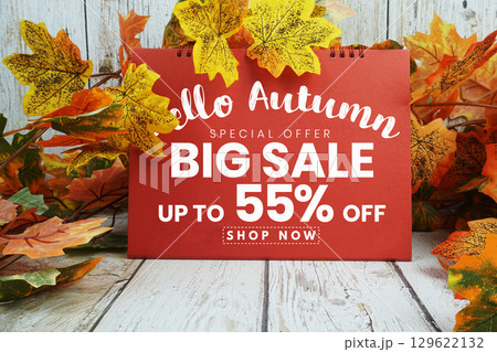 Hello Autumn Big Sale 55% text with maple leaf decorated on wooden background 129622132