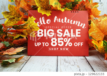 Hello Autumn Big Sale 85% text with maple leaf decorated on wooden background 129622133