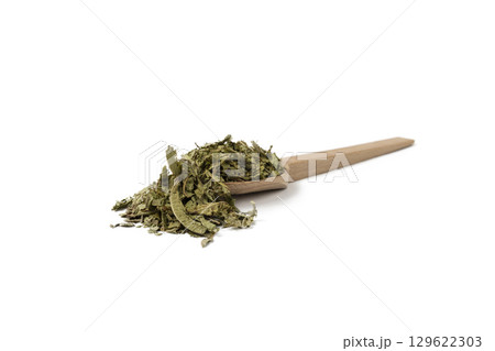 Dried leaves o Lemon verbena in latin Aloysia citrodora on wooden spoon isolated on white background. Medicinal. herb. 129622303
