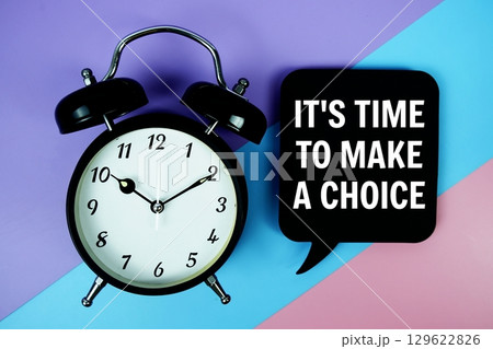 It's Time To Make A Choice text on speech bubble with alarm clock top view on blue, purple and pink geometric background It's Time To Make A Choice text on speech bubble with alarm clock top view on blue, purple and pink geometric background 129622826