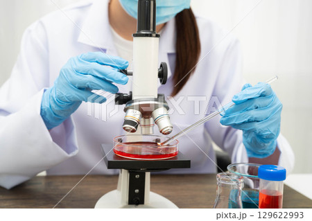 Scientist medical professional use microscope for research in science laboratory. Scientist medical professional use microscope for research in science laboratory. 129622993