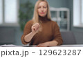 A woman is watching holographic screens. 129623287
