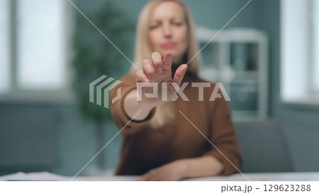 A woman is watching holographic screens. A woman is watching holographic screens. 129623288