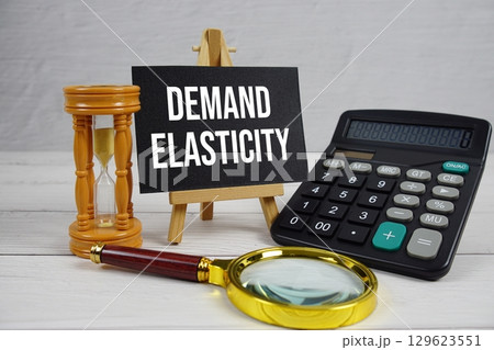 Demand Elasticity text with magnifying glass and calculator on wooden background Demand Elasticity text with magnifying glass and calculator on wooden background 129623551