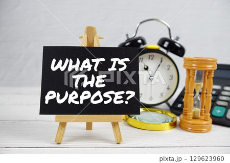 What Is The Purpose? text with magnifying glass and calculator on wooden background 129623960
