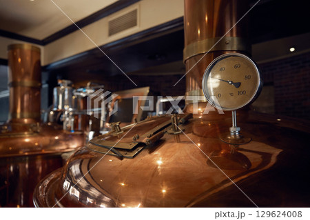 Copper brewery with thermometer in a brewery setting 129624008