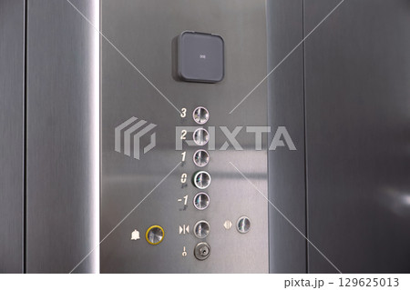 Close-Up of Metal Elevator Buttons with Floor Indicators 129625013
