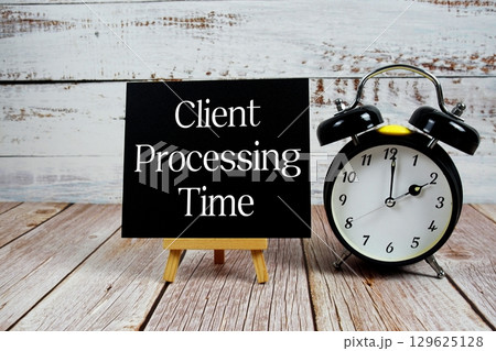 Client Processing Time text with easel and alarm clock on wooden background 129625128