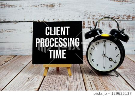 Client Processing Time text with easel and alarm clock on wooden background Client Processing Time text with easel and alarm clock on wooden background 129625137